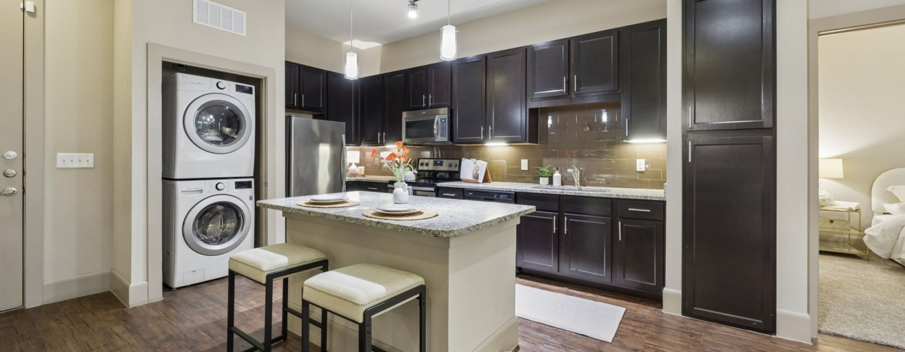 An interior view of a kitchen with kitchen cabinetr