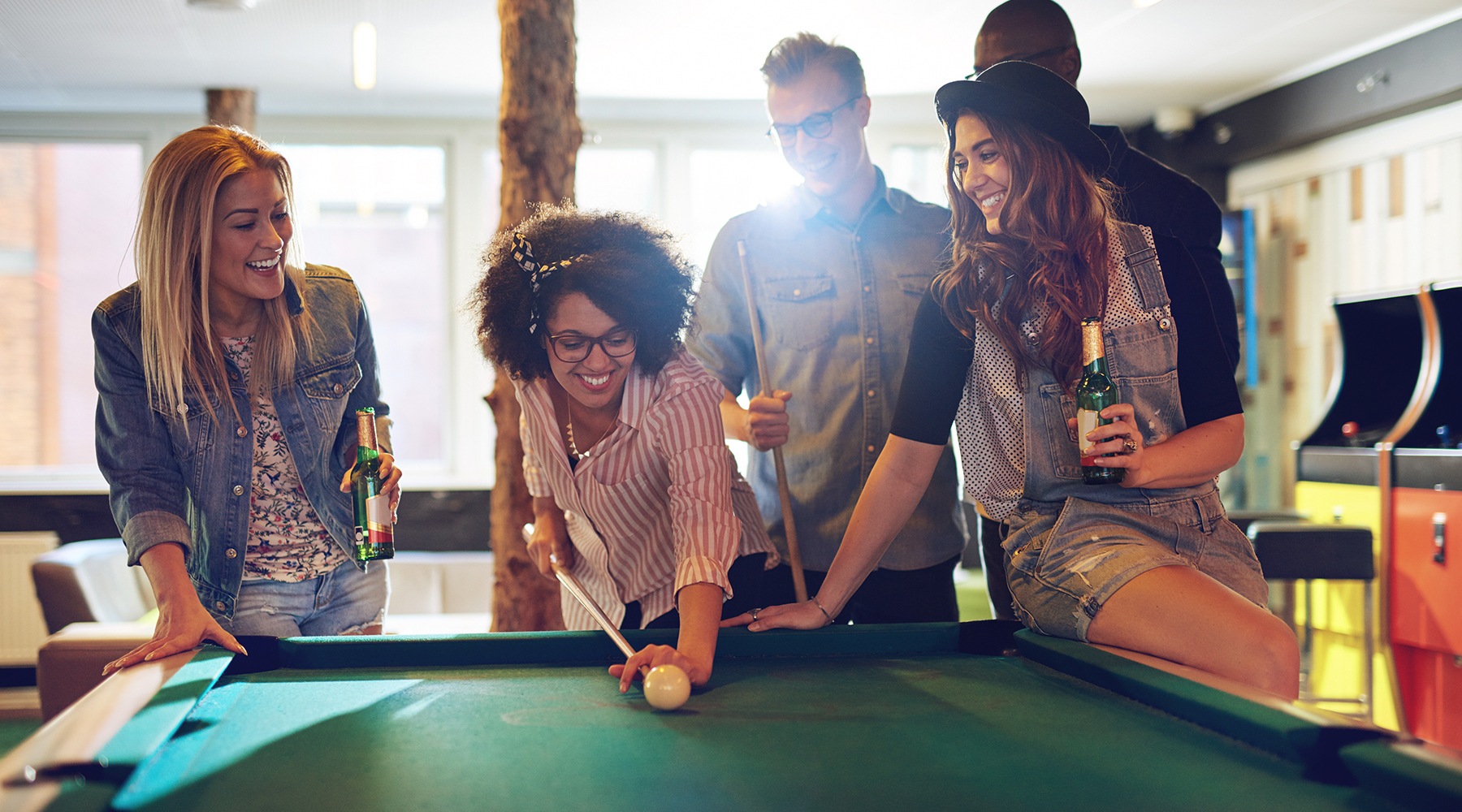 friends playing pool and smiling friends playing pool and smiling