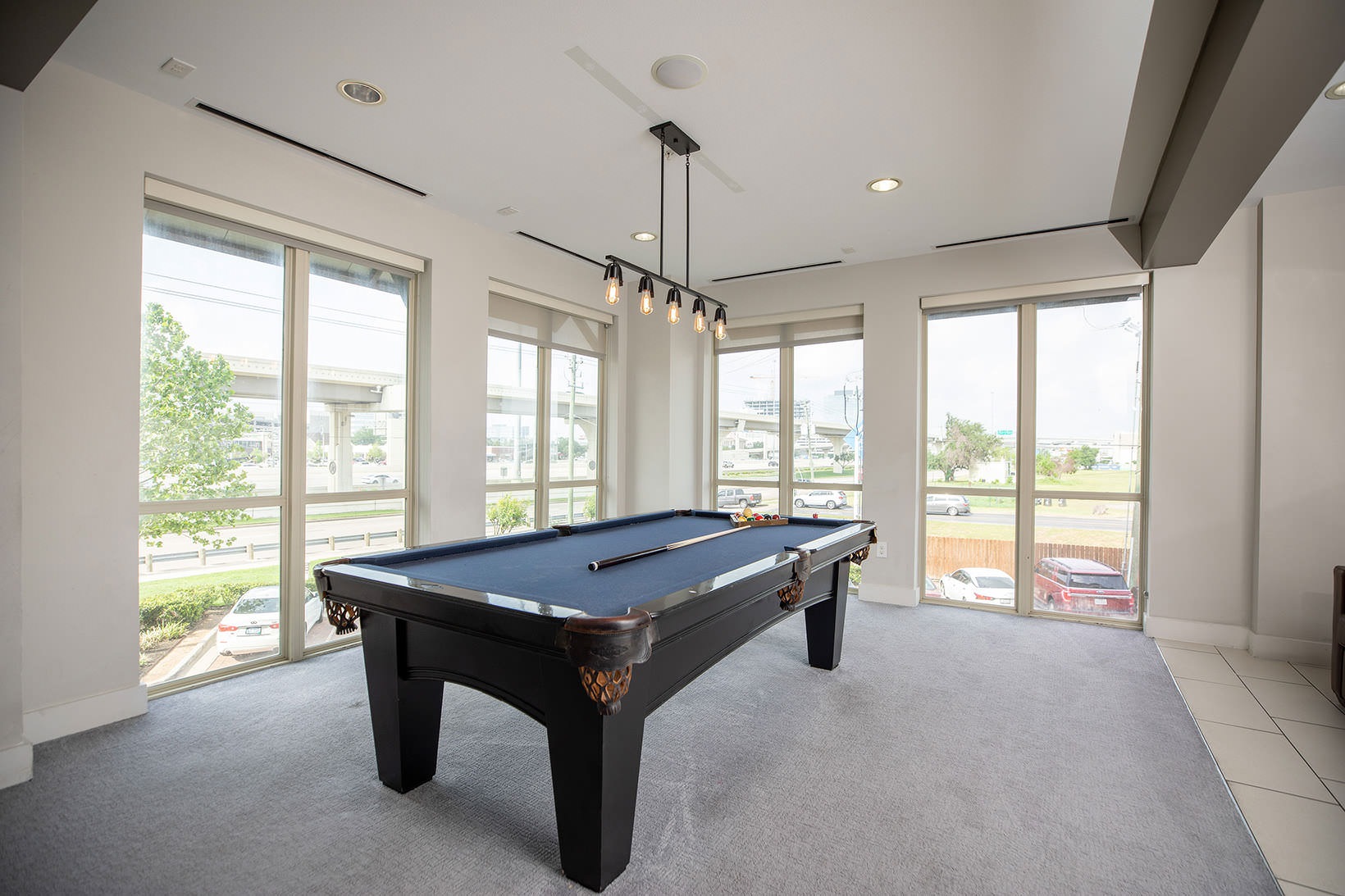 Clubhouse large windows surround billiards table