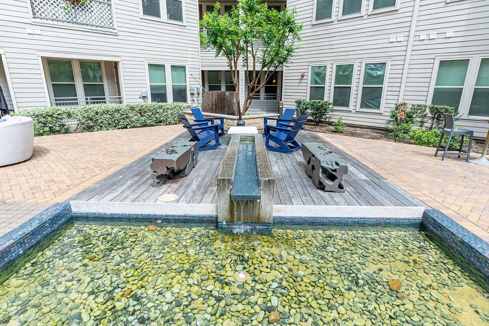 Courtyard water feature, and rocking chairs on courtyard platform