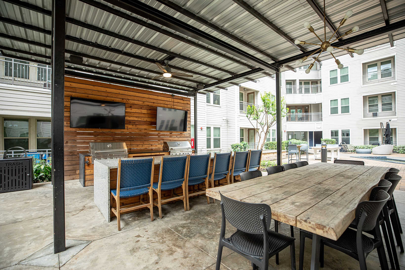 Grills ceiling fans and lights under covered patio