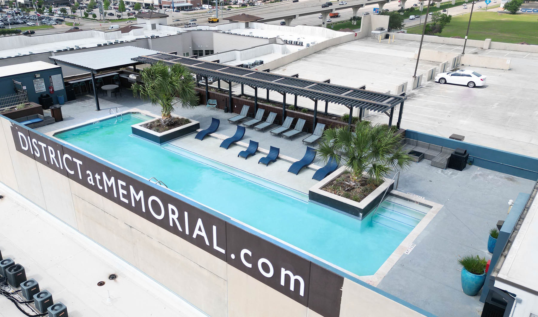 Living Begins Here rooftop pool with in-pool lounge chairs